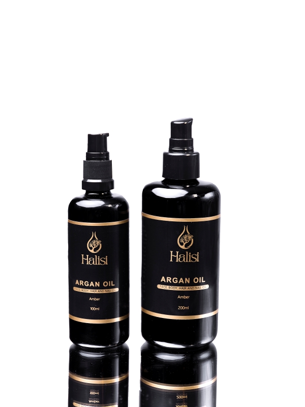 Two Black Glass Halisi Argan Oil Pump Bottles Shown Against A Clean White Background.